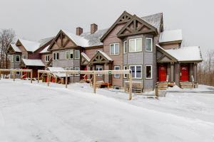 a large house with snow on the ground at Jay Peak Village Home 367A&B in Jay