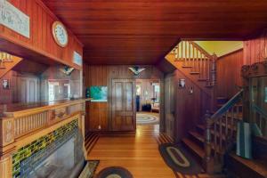 a living room with wooden walls and a large television at Garden Island's Maple in Charlotte