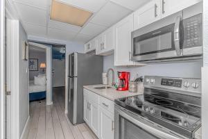 a kitchen with a stainless steel refrigerator and microwave at Boardwalk 439 & 440 in Myrtle Beach