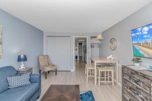 a living room with a couch and a table at Boardwalk 439 & 440 in Myrtle Beach +40 photos