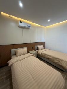 a room with two beds in a room at Royal Pearl Villa 1 in Sowayma