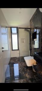 a bathroom with a tub and a toilet and a sink at Royal Pearl Villa 1 in Sowayma +9 photos