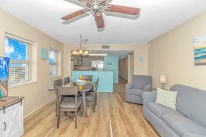 a living room with a couch and a table with chairs at Atlantica 757 in Myrtle Beach