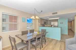 a dining room and kitchen with a table and chairs at Atlantica 757 in Myrtle Beach