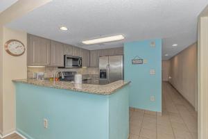 a kitchen with a blue island in a room at Atlantica 757 in Myrtle Beach