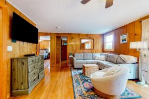 a living room with a couch and a tv at Potter's Place in Jamaica