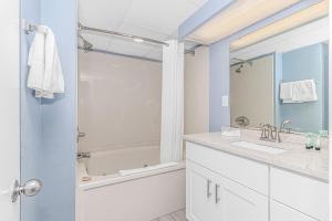 a bathroom with a shower and a sink and a mirror at Oceanview Studio at Boardwalk Resort 440 in Myrtle Beach