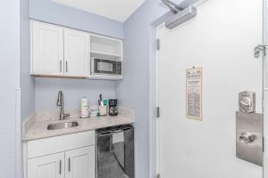 a kitchen with a sink and a microwave at Oceanview Studio at Boardwalk Resort 440 in Myrtle Beach