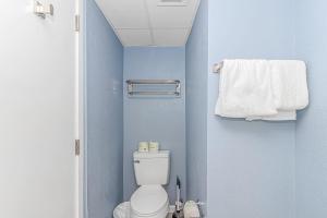 a small bathroom with a toilet and a towel at Oceanview Studio at Boardwalk Resort 440 in Myrtle Beach