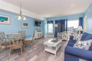 a living room with a couch and a table at The Palace 1513 in Myrtle Beach