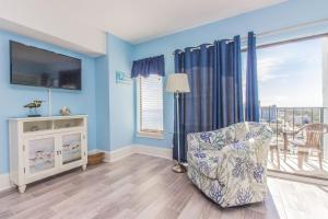 a living room with a chair and a television at The Palace 1513 in Myrtle Beach +43 photos