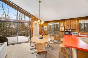 a kitchen and dining room with a table and chairs at Dwight Road Getaway in Quechee