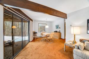 a living room with a couch and a table at Dwight Road Getaway in Quechee