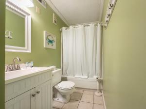 a bathroom with a toilet and a sink and a shower at A Place at the Beach 406 in Myrtle Beach