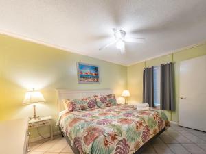 a bedroom with a bed and a ceiling fan at A Place at the Beach 406 in Myrtle Beach