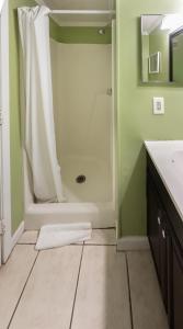 a bathroom with a shower and a white sink at A Place at the Beach 406 in Myrtle Beach +19 photos