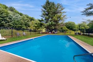 a blue swimming pool with chairs and trees at Powderhound 52 in Warren