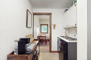 a kitchen with a counter with a stove top oven at Powderhound 52 in Warren