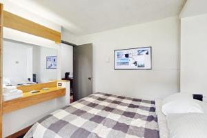 a bedroom with a checkered bed and a sink at Powderhound 52 in Warren +18 photos