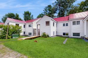 a large white house with a red roof at Powderhound 52 in Warren