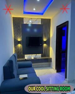 a living room with a blue couch and a flat screen tv at Britney Luxury Apartment in Irete