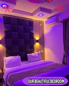 a bedroom with a bed with purple lights on it at Britney Luxury Apartment in Irete