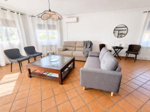 a living room with a couch and a coffee table at El encinar de las nieves - Piscina privada, cerca de Toledo y Puy du Fou in Toledo