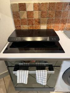 a stove top oven under a counter in a kitchen at Bright Nîmes Center Flat with Terrace in Nîmes +12 photos