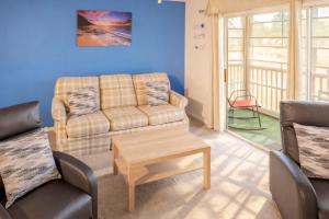 a living room with a couch and a table at Charming Golf Getaway! River Oaks 19E in Myrtle Beach