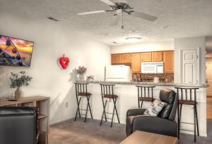 a kitchen with a bar with stools at Charming Golf Getaway! River Oaks 19E in Myrtle Beach