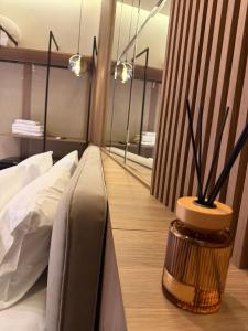 a bedroom with a bed and a mirror on the wall at The cosy inn vlora in Vlorë