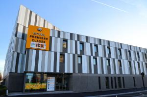 a building with a sign on the side of it at Premiere Classe Le Havre Centre-LES DOCKS in Le Havre