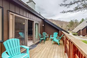 a deck with blue rocking chairs on a house at Battleground 2 in Irasville