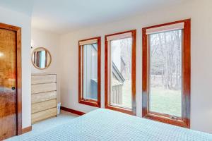 a bedroom with a bed and two windows at Battleground 2 in Irasville +70 photos