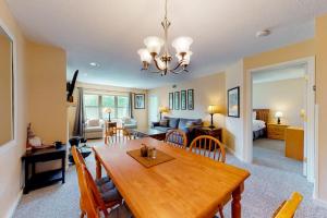 a dining room and living room with a wooden table at Winterplace G205 in Ludlow
