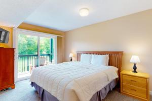 a bedroom with a large bed and a window at Winterplace G205 in Ludlow +38 photos