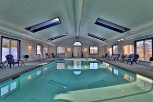 a swimming pool in a house with chairs in it at Winterplace G205 in Ludlow