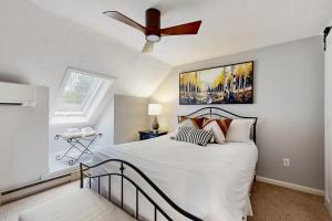 a bedroom with a bed with a ceiling fan at Apres Ski Haven in Quechee +83 photos