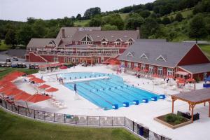 a large swimming pool in front of a large building at Apres Ski Haven in Quechee
