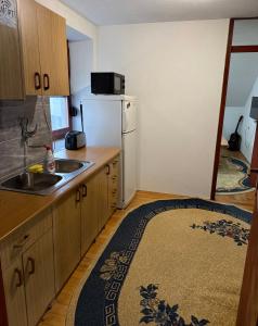 a kitchen with a sink and a refrigerator at Apart Jajce in Jajce