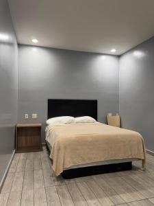 a bedroom with a large bed and a fireplace at Casa Motel in Los Angeles