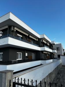 a building with a fence in front of it at Golden Sands in Keramoti +16 photos