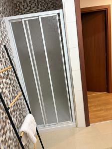 a sliding glass door with a dog on a stroller at Kasa102 in Gouveia