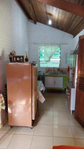 a kitchen with a stainless steel refrigerator in a room at Chácara chalé in Juquitiba