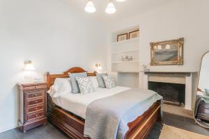 a bedroom with a bed and a fireplace at Villa Casa Pini by Rent All Como in Bellagio