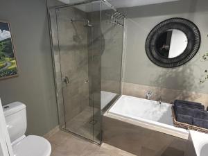 a bathroom with a shower and a tub and a toilet at Rye Hide Out - Rye beach retreat in Rye +22 photos