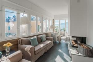 a living room with a couch and a fireplace at Villa Casa Pini by Rent All Como in Bellagio