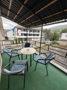 a patio with a table and chairs and a view of a building at Apart Jajce in Jajce