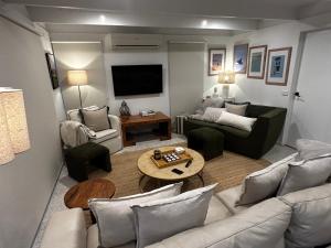 a living room with a couch and a table at Rye Hide Out - Rye beach retreat in Rye