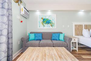 a living room with a couch and a bed at Ocean Front Condo Sea Mist 20509 in Myrtle Beach